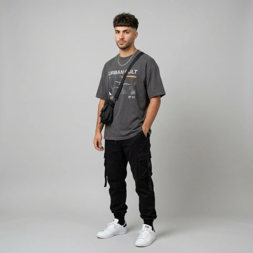 A 21-year-old male model with a Wavy Curly Edgar haircut wearing a trendy streetwear outfit.
